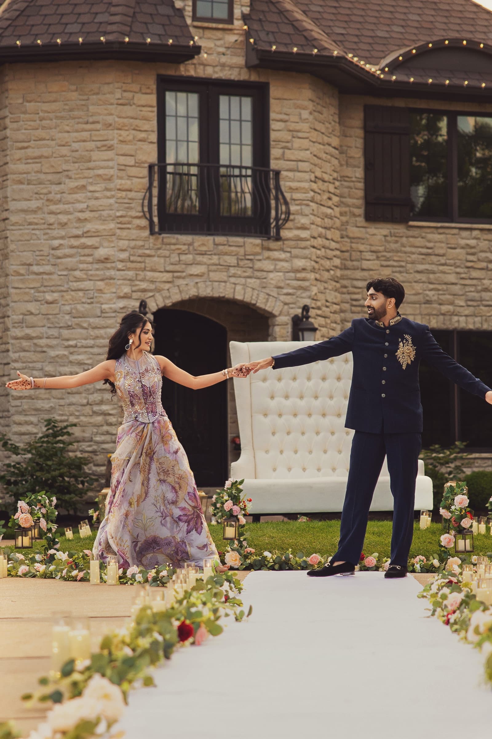 Aniketa and Dhruv hold hands at the outdoor ceremony setup during their engagement celebration in Columbia, MO