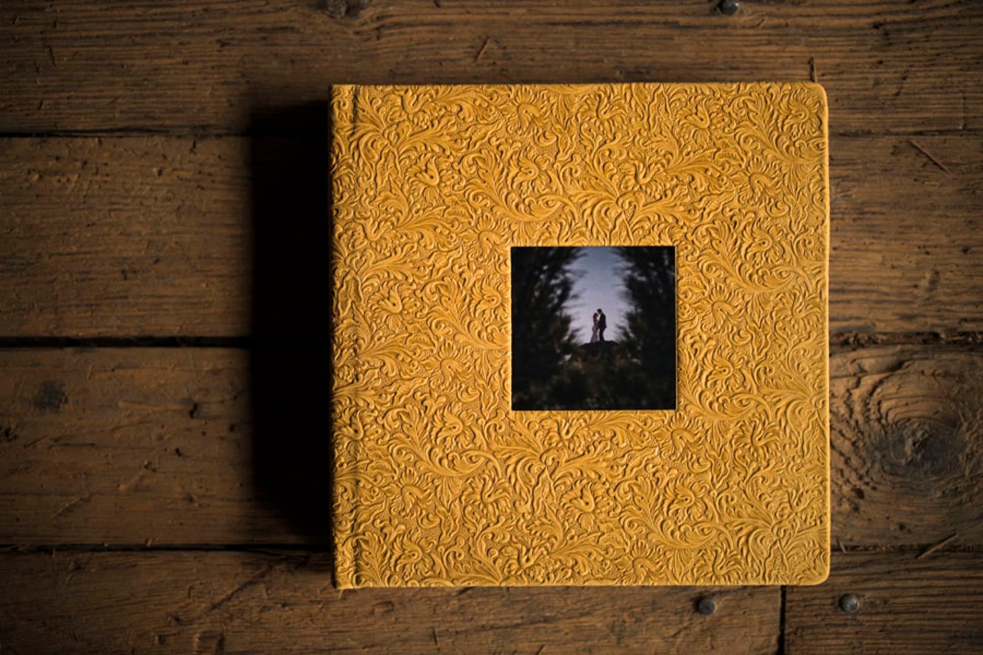 Italian-leather heirloom album with a custom debossed cover and a photo cameo