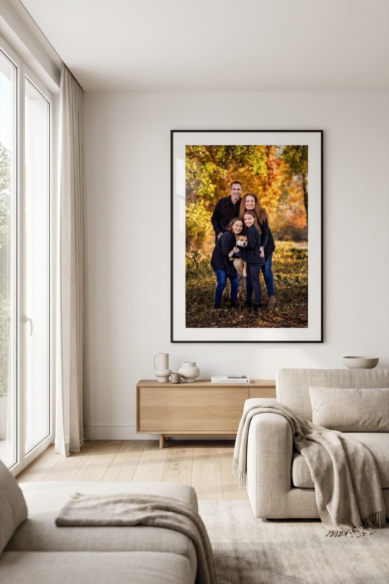 Family portrait framed as a matted fine-art print on the wall of a bright luxury living room