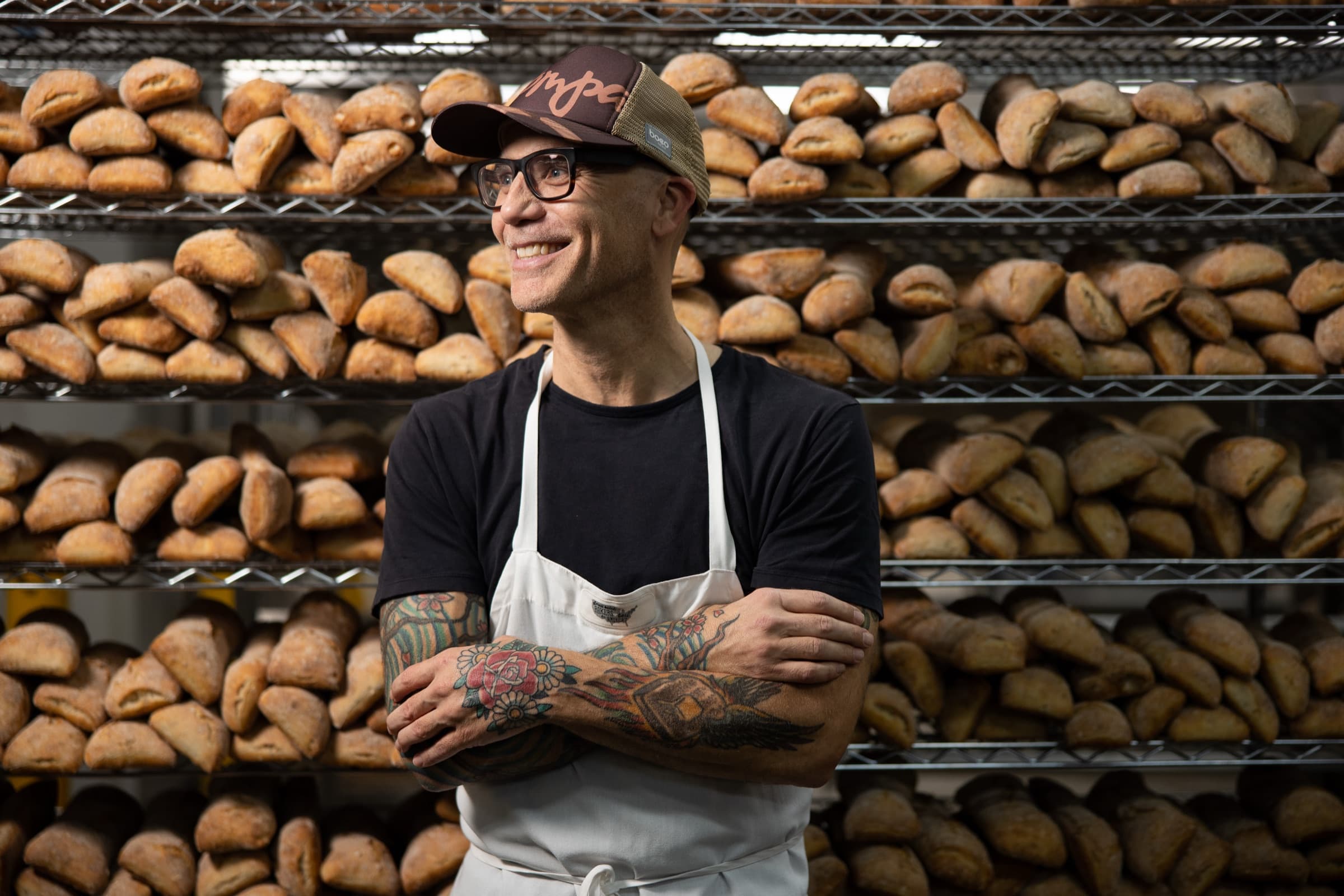On-location personal brand portrait of a St. Louis baker at his bread racks by Zach Dalin Photography