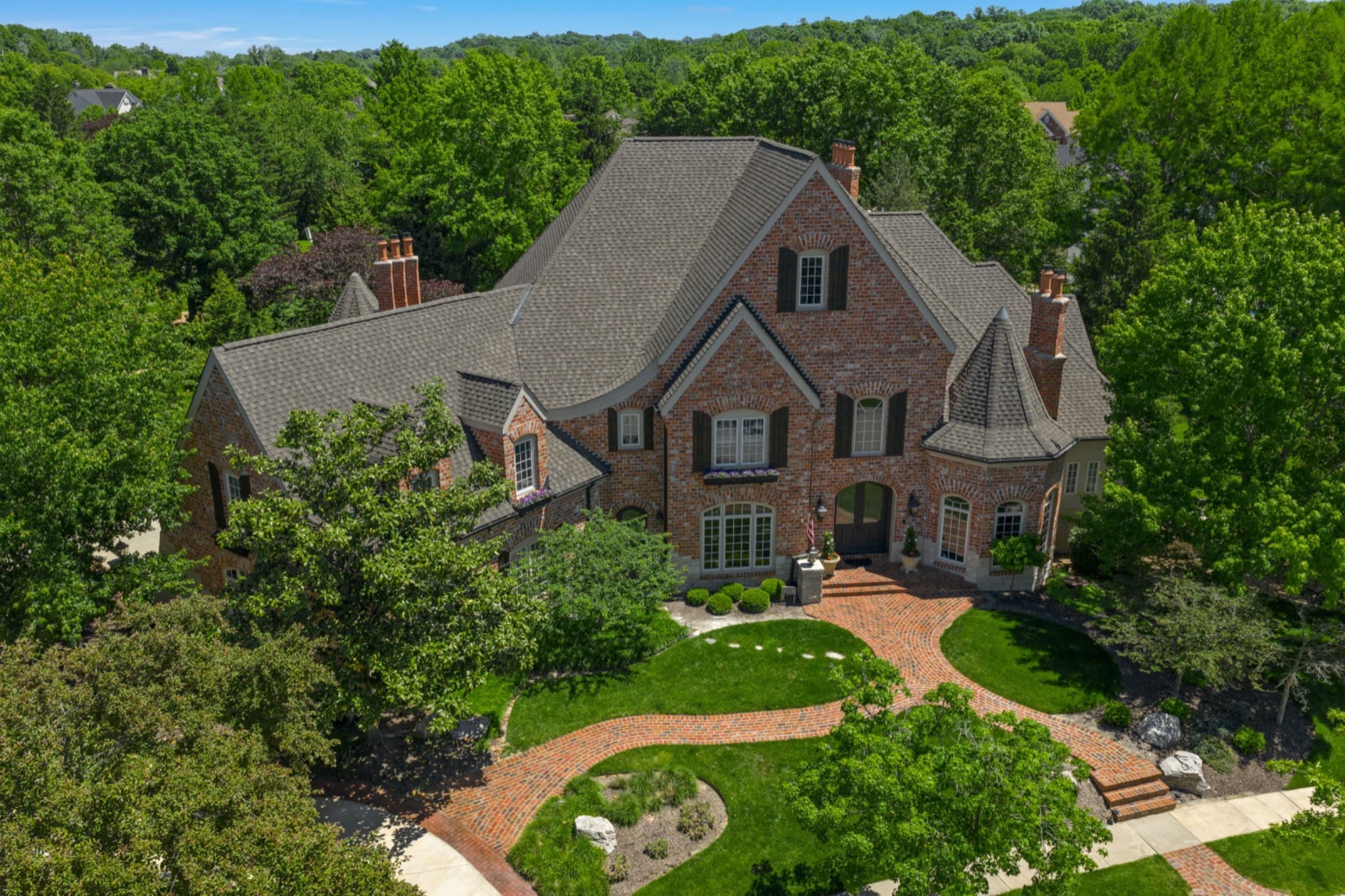 Aerial view of a brick luxury estate among mature trees in St. Louis, real estate photography by Zach Dalin